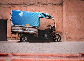 Motorcycle on road against wall