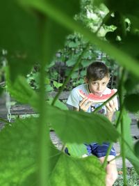 The boy enjoys the taste of ripe watermelon 