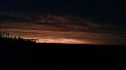 Scenic view of silhouette trees against sky at sunset