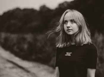 Portrait of young woman standing outdoors