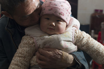 Portrait of cute baby boy with his grandfather