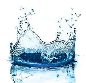 Close-up of splashing water against white background