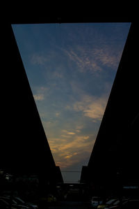 Silhouette of buildings against sky at sunset