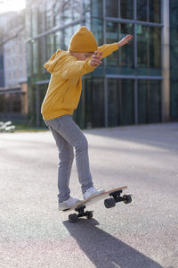 A little skater doing a jump on his skateboard. outdoors activity concept. lifestyle scene