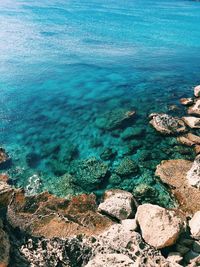 High angle view of rocks by sea