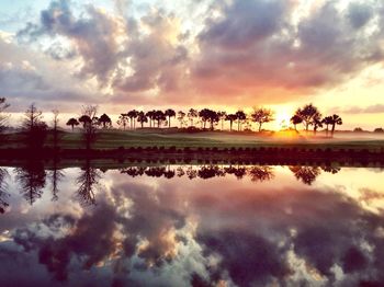 Scenic view of lake against cloudy sky