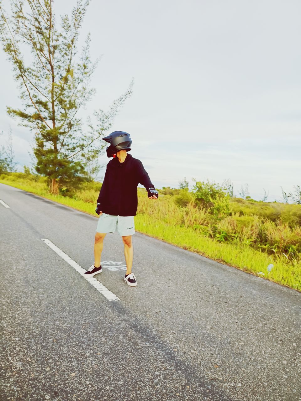 road, one person, full length, transportation, day, sky, nature, casual clothing, clothing, leisure activity, lifestyles, yellow, plant, child, childhood, motion, rear view, asphalt, longboard, the way forward, tree, adult, outdoors, on the move, road marking, sports, walking, person, copy space, city, hat, men, footwear, street, women, sunlight, standing, skateboarding equipment, running, symbol