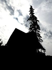 Low angle view of building against cloudy sky