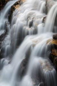 Beautiful cascade of water flowing in a waterfall in nordic mountain area.