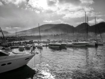 Boats sailing in sea against sky