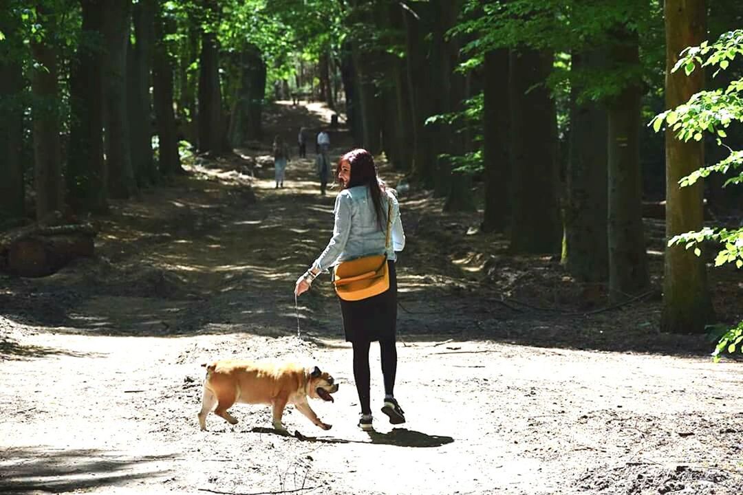 WOMAN STANDING IN FOREST