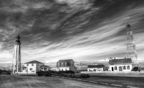 Buildings against cloudy sky