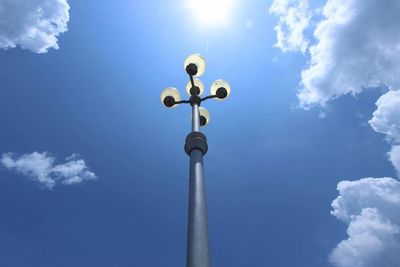 Low angle view of floodlight against blue sky on sunny day