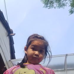 Portrait of cute girl against sky