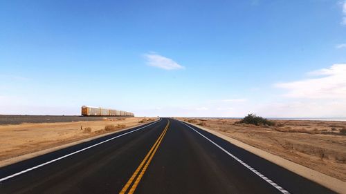 Empty road along landscape