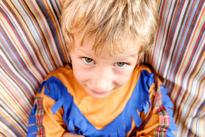 Portrait of cute boy lying on bed