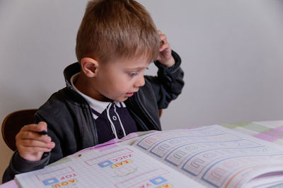 Portrait of boy holding book