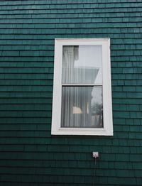 Reflection of building on house window