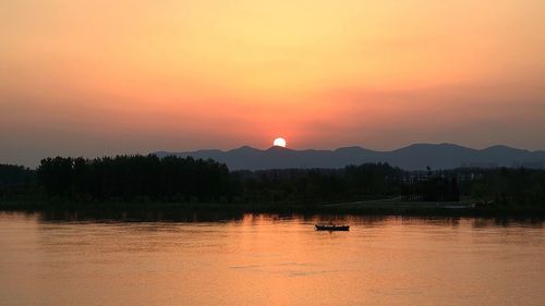 Scenic view of lake against sky during sunset