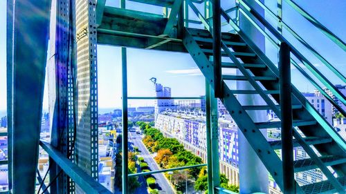 Modern buildings against sky seen through glass window