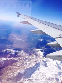 Cropped image of airplane flying over landscape
