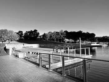 Pier over lake against clear sky