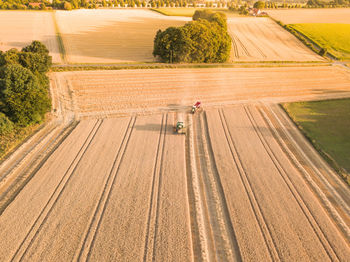 Aerial view of combine harvesters on agriculture landscape