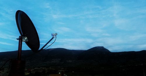 Low angle view of mountain range against cloudy sky