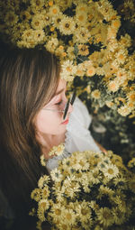 Midsection of woman holding flowering plant