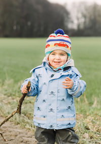 Portrait of cute girl standing on field