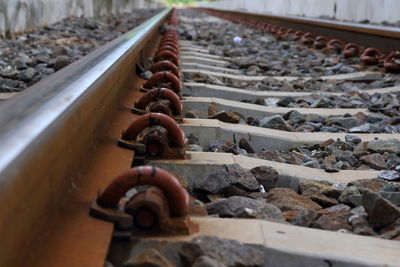 Close-up of rusty chain on railroad track