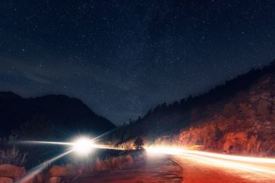 Scenic view of illuminated mountains against clear sky at night