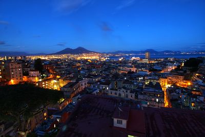 High angle view of illuminated cityscape against sky at night