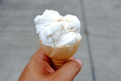 Cropped image of person holding ice cream