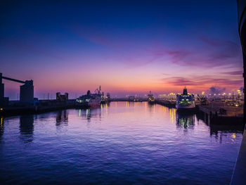 Boats in harbor at sunset