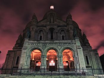 Low angle view of illuminated cathedral against sky at night