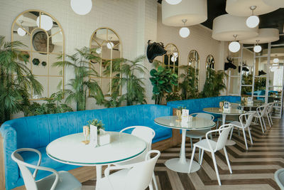 Empty chairs and tables in restaurant