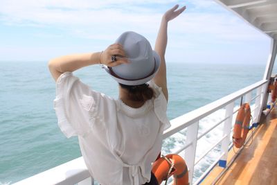 Rear view of woman traveling on boat in sea