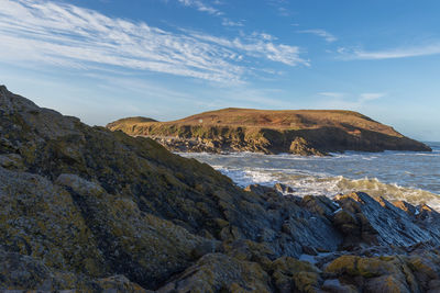 Scenic view of rocks in sea against sky