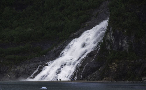 Scenic view of waterfall against sky