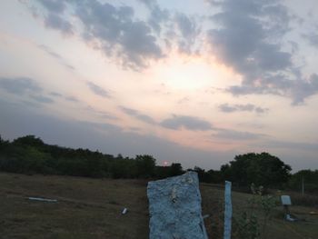 Scenic view of field against sky at sunset