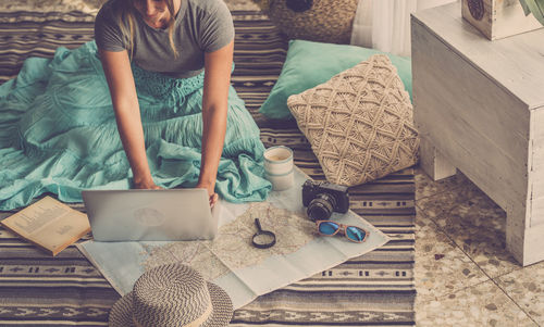 High angle view of woman holding table at home