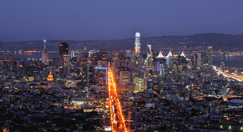 High angle view of illuminated cityscape against sky at night