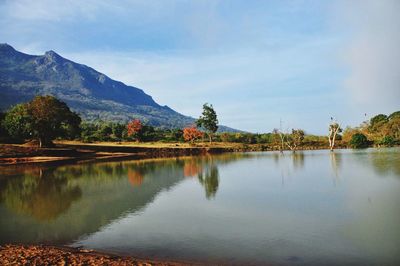 Scenic view of lake and mountains against sky