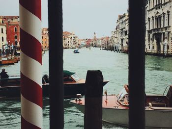 Boats in river with buildings in background