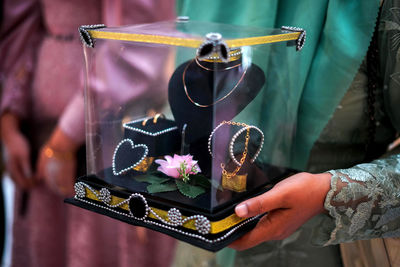 Midsection of woman holding wedding gift box decoration