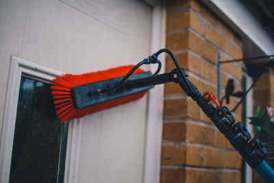 Close-up of bicycle against red wall