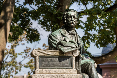 Low angle view of statue against trees