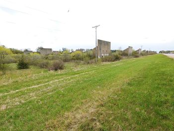 Abandoned building on field against sky