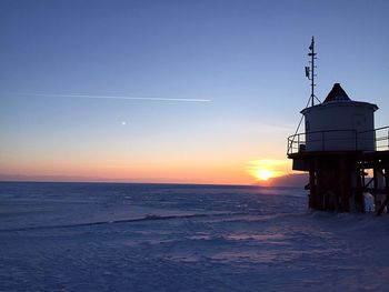 Scenic view of sea against clear sky during sunset